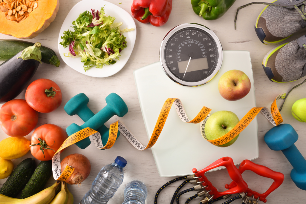 Sports items equipment and healthy food on wooden table for health care weight loss and healthy life. Top view Horizontal composition.