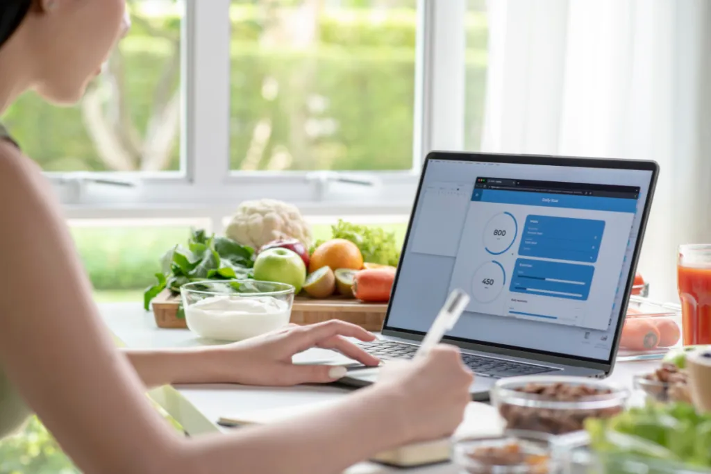 Women Nutritionist checking data from laptop
