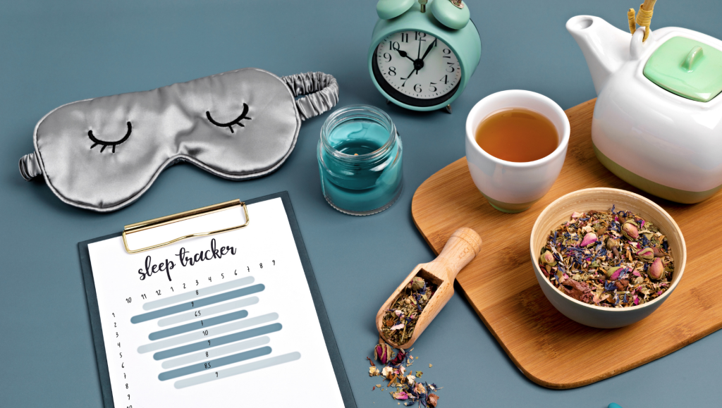 Classic alarm clock, sleeping mask, sleep tracker and herbal tea on blue background. Minimal concept of rest, quality of sleep, good night , insomnia, relaxation, 